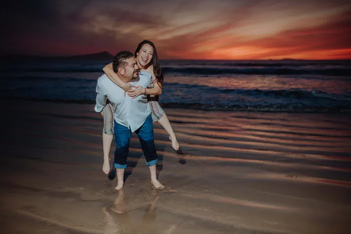 A couple laughing at the ocean shore
