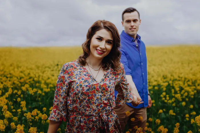 A couple looking at us in a yellow flower field