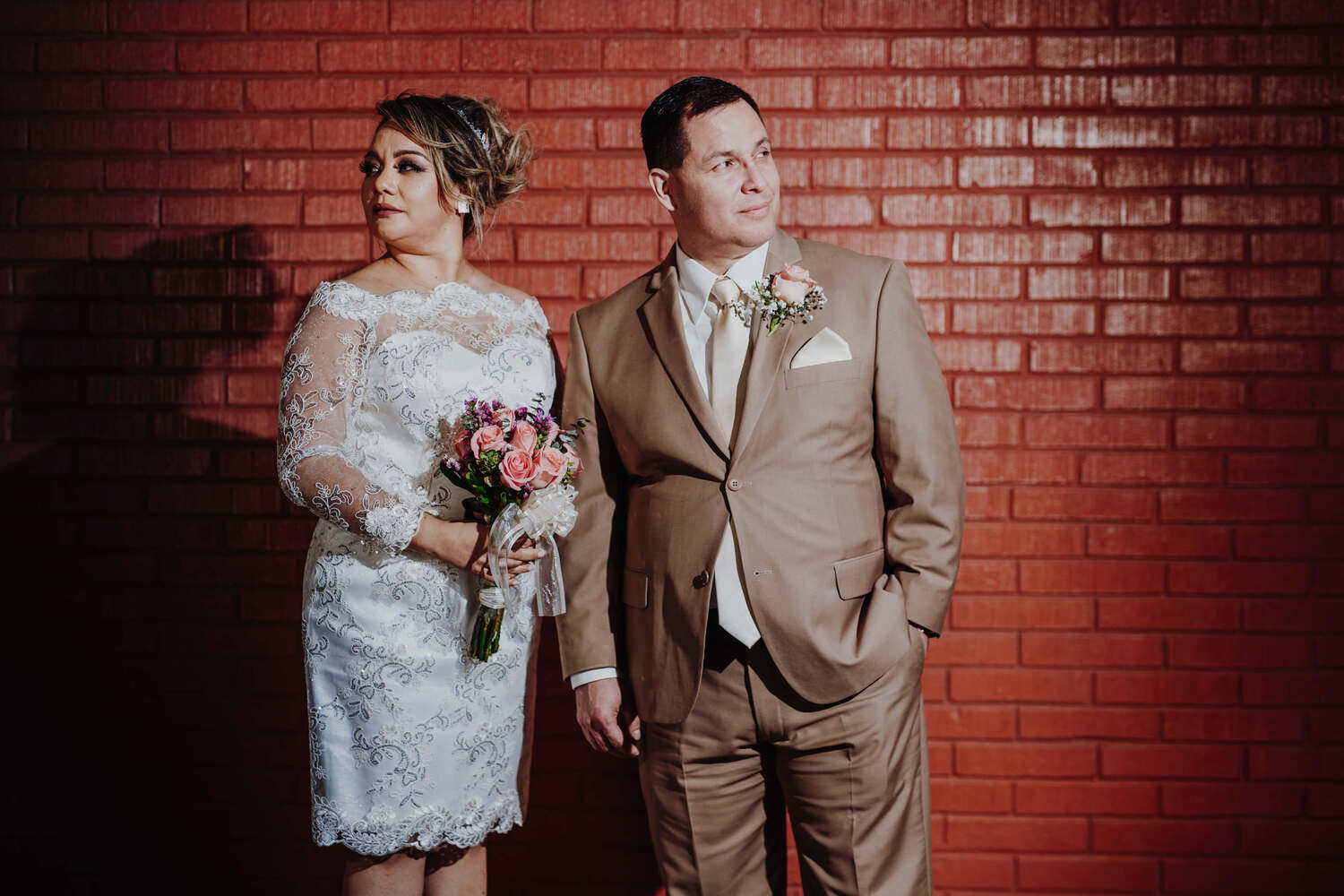 A beautiful couple in front of a red wall