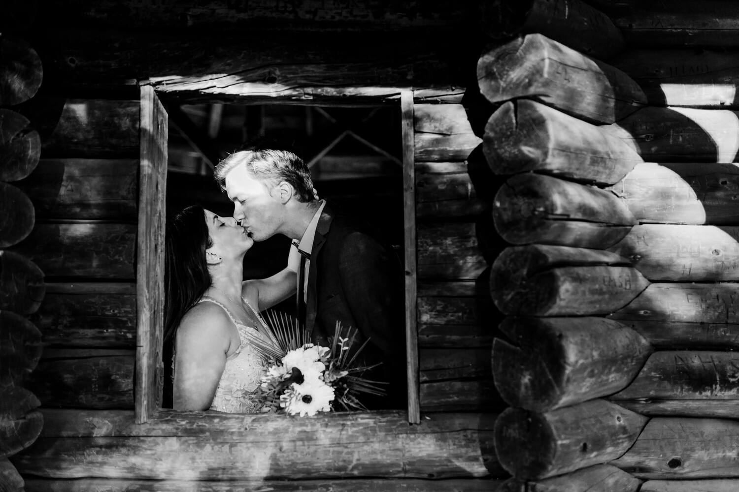 A couple kissing passionately in a wooden hut